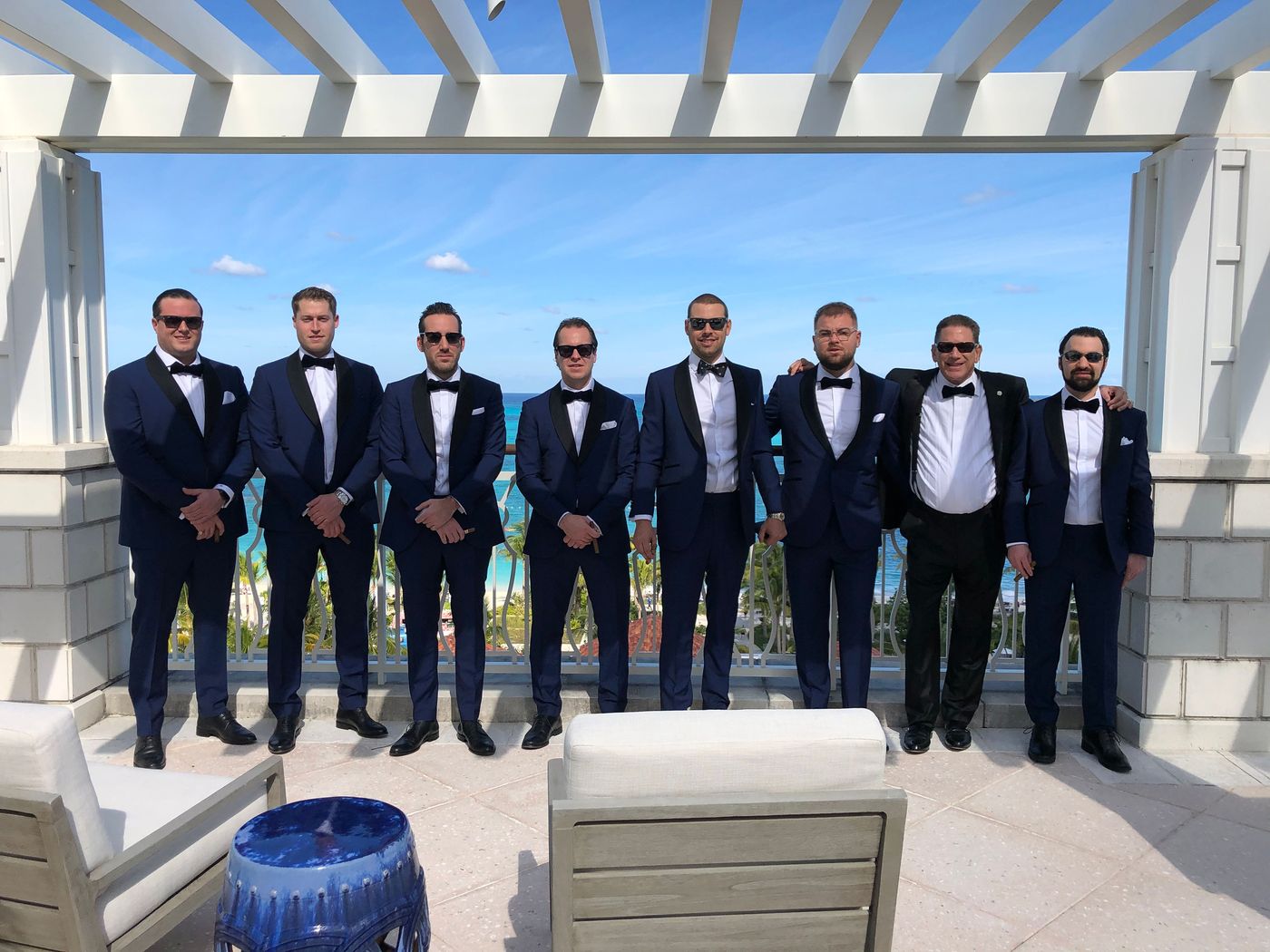 Groomsmen in coordinated navy bespoke suits