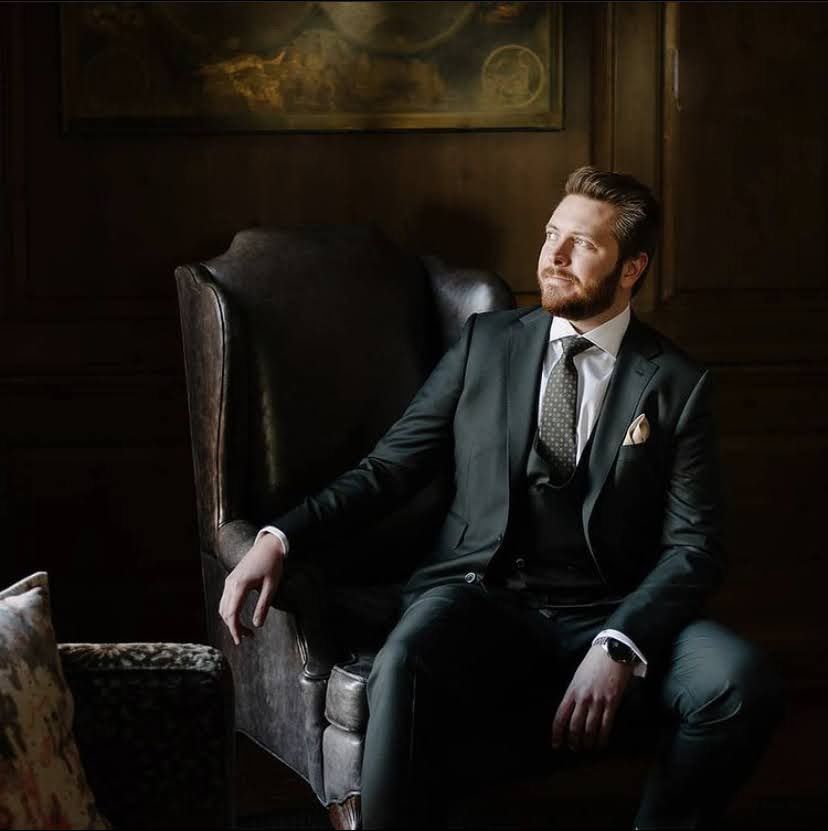Client in a charcoal bespoke three-piece suit